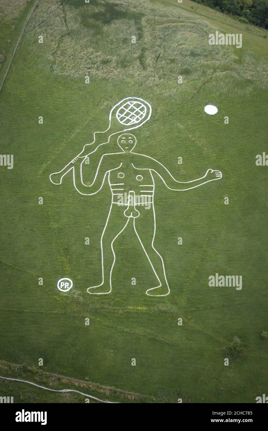 EDITORIAL USE ONLY  An aerial view of the 180ft Cerne Abbas Giant in Dorset, holding a tennis racket and a new set of balls, which bookmaker Paddy Power added to mark the start of the Wimbledon tennis tournament. Stock Photo
