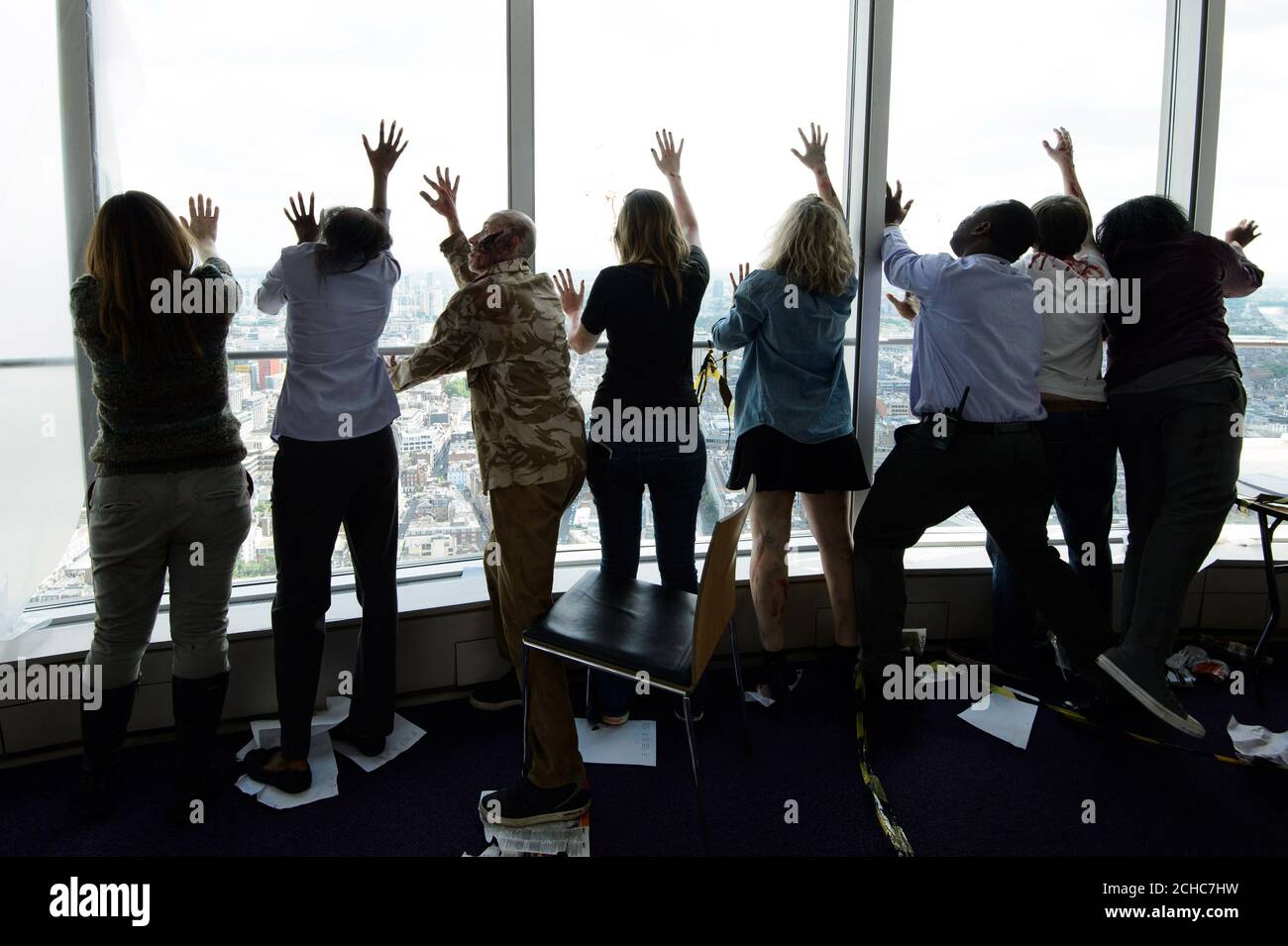 EDITORIAL USE ONLY 'Zombies' take over the BT Tower in London to celebrate the mid-season finale of &Ograve;Fear the Walking Dead&Oacute;, which airs tomorrow, Monday July 10th on AMC, exclusively on BT TV and BT Sport Pack. Stock Photo