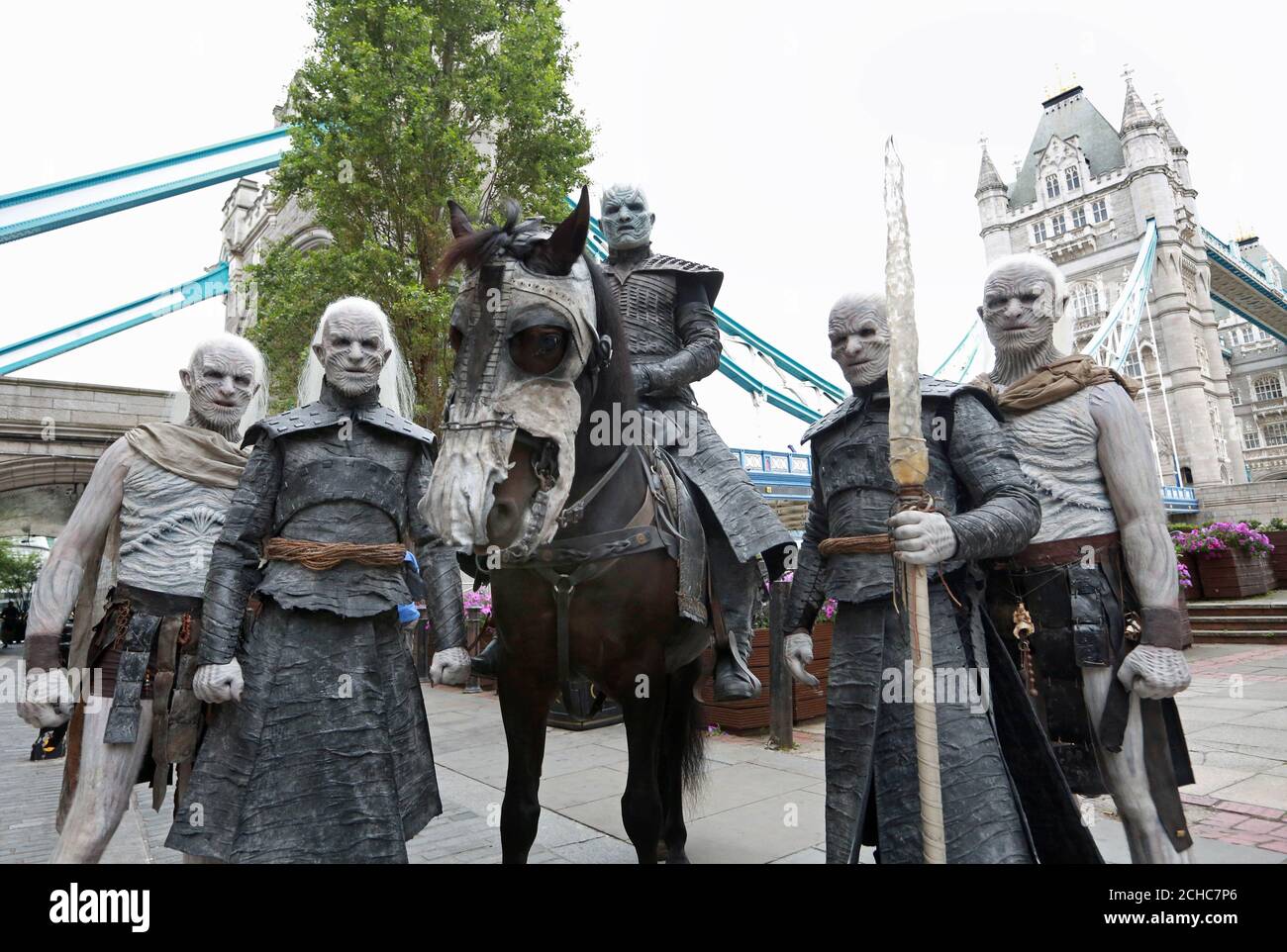 Five models dressed as White Walkers from Game of Thrones, led by the Night King on horseback, pass by Tower Bridge in London to celebrate the upcoming start of season 7 of the television show, which airs at 9pm on Monday July 17th on Sky Atlantic. Stock Photo