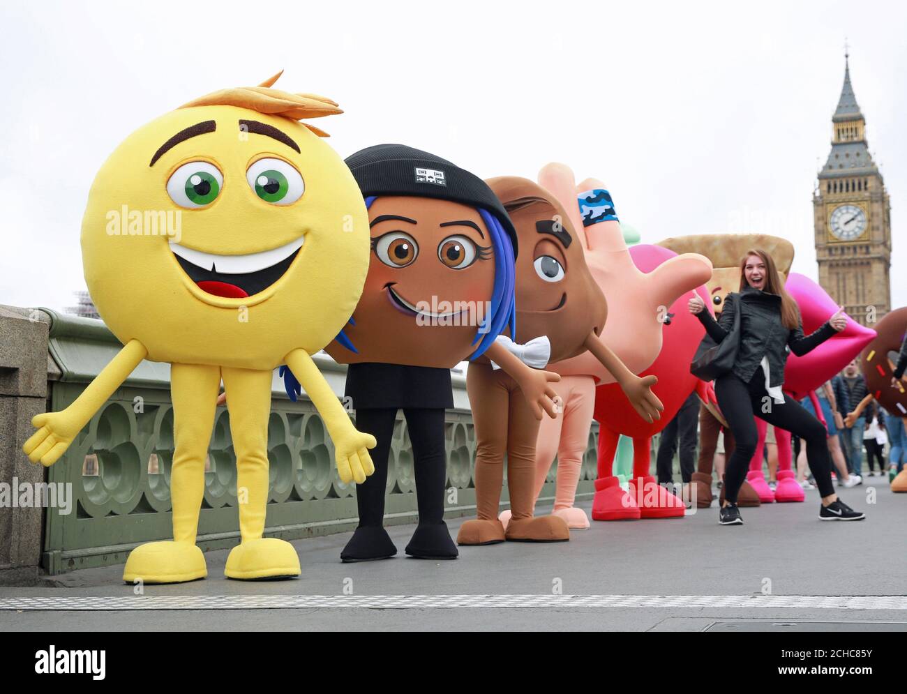 EDITORIAL USE ONLY Characters from The Emoji Movie walk over