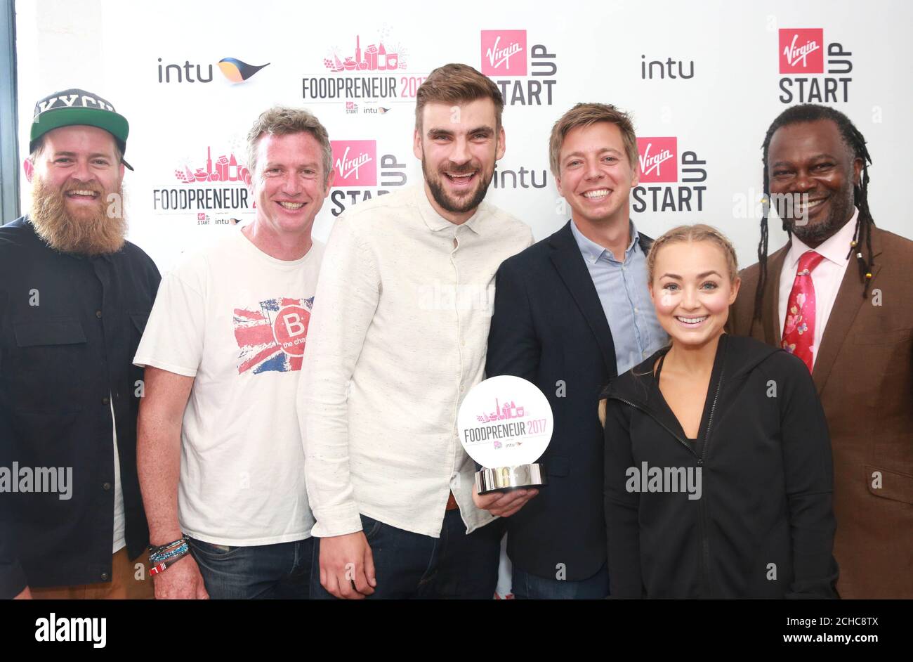 (Left to right) Finalists Jim Cregan, founder of Jimmy's Iced Coffee, Paul Lindley, founder of Ella's Kitchen, Andy Allen and Nick Coleman, from Snaffling Pig, Alice Liveing, aka Clean Eating Alice and Judge Levi Roots, founder of Reggae Reggae Sauce, at the intu and Virgin StartUp's Foodpreneur competition at Virgin Startup HQ in London, walking away with six week's free retail space at intu Lakeside to run their new business. Stock Photo