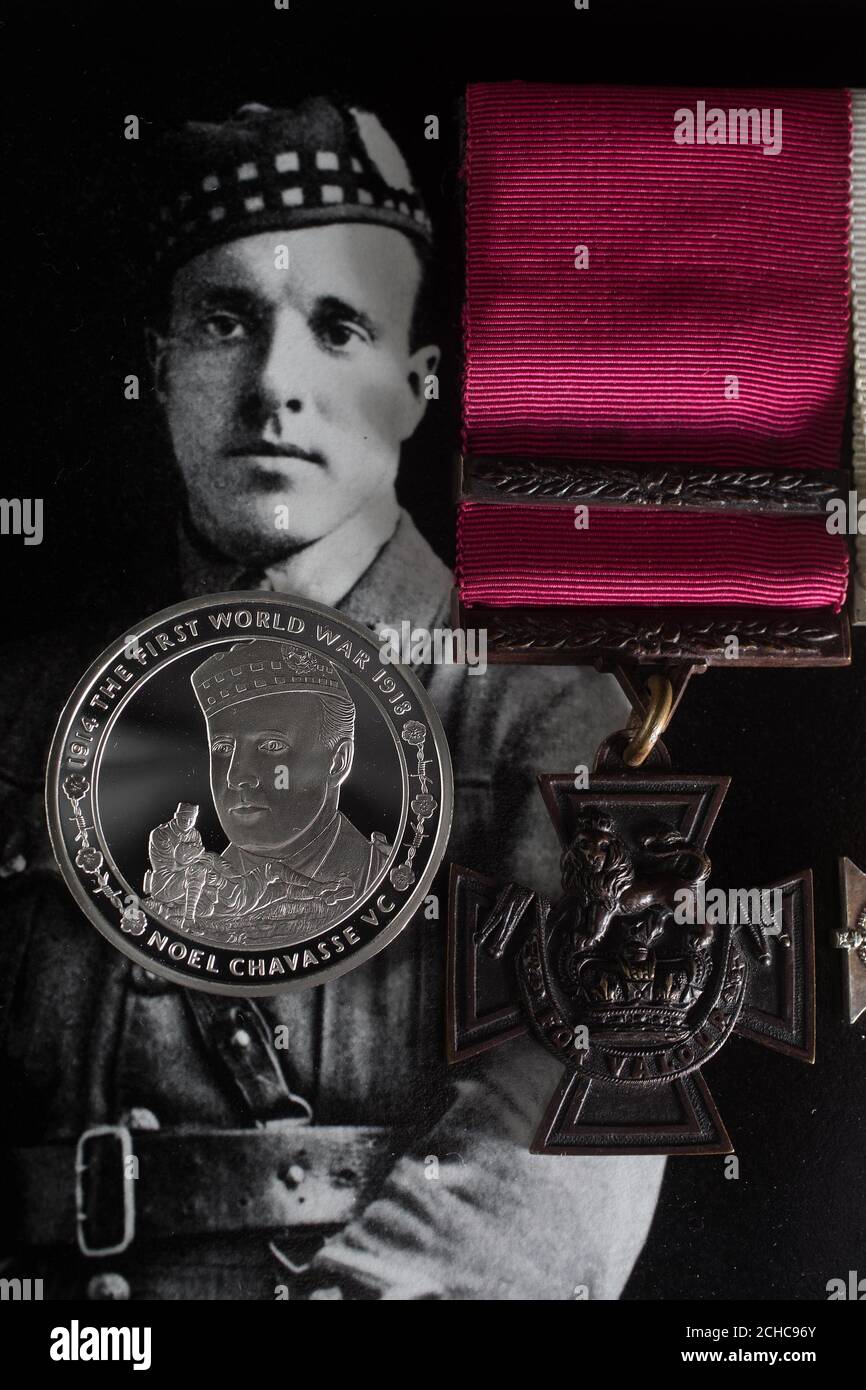 EMBARGOED TO 0001 MONDAY JULY 31 EDITORIAL USE ONLY A commemorative &pound;5 coin, which honours First World War hero Captain Noel Chavasse, unveiled by The Royal Mint at the Imperial War Museum in London, alongside his Victoria Cross that is part of the Lord Ashcroft collection.  Stock Photo