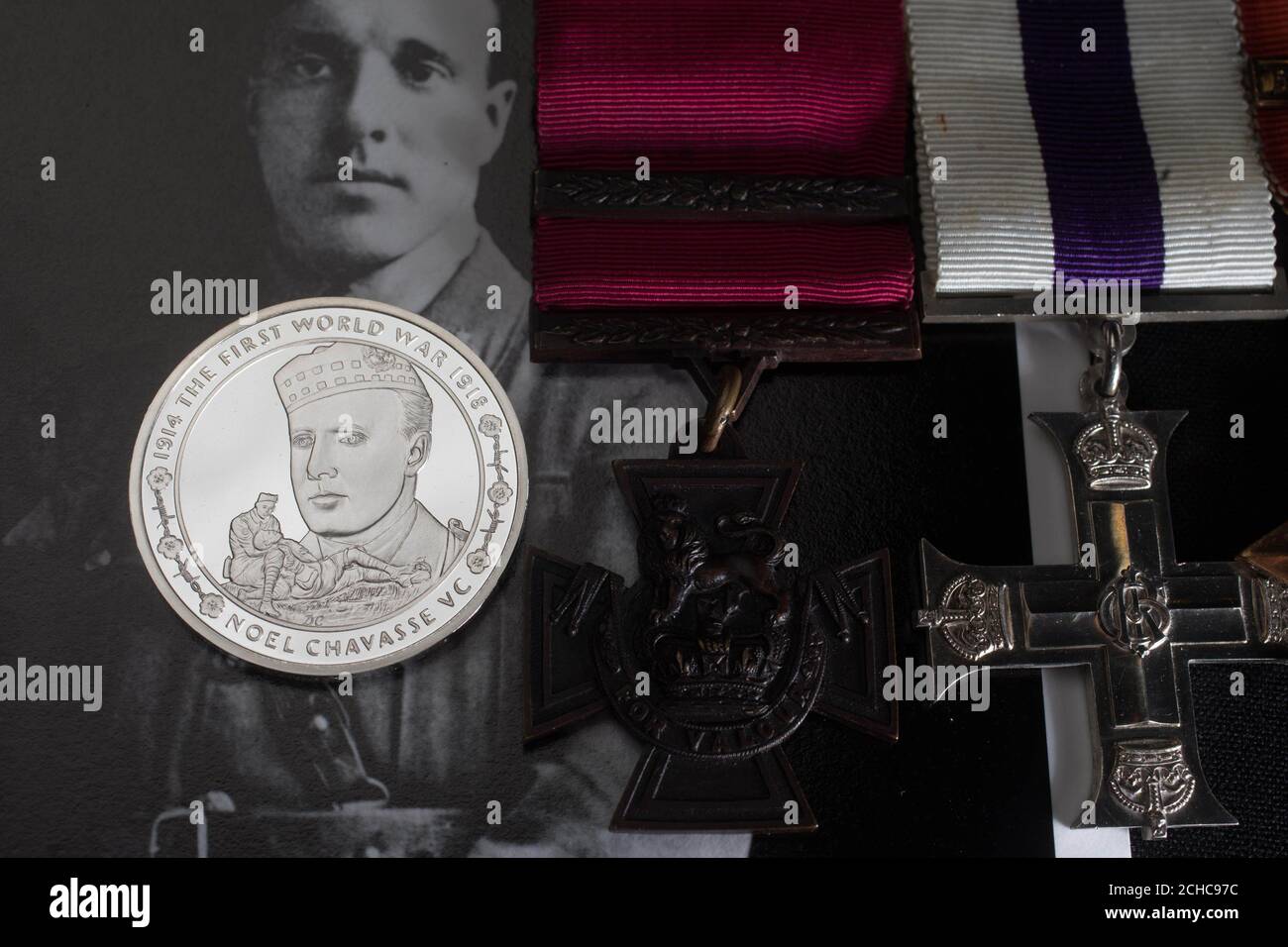 EDITORIAL USE ONLY A commemorative &pound;5 coin, which honours First World War hero Captain Noel Chavasse, unveiled by The Royal Mint at the Imperial War Museum in London, alongside his Victoria Cross that is part of the Lord Ashcroft collection.  Stock Photo