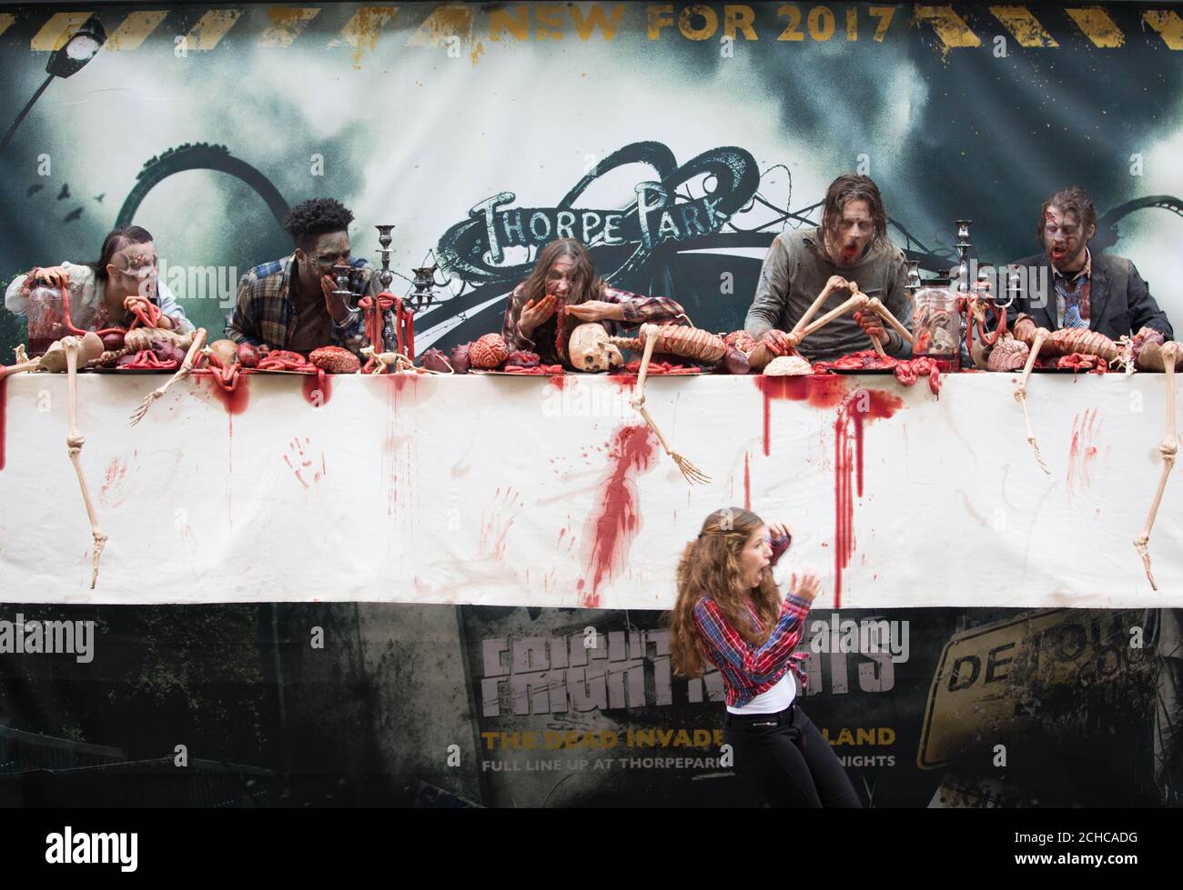 EDITORIAL USE ONLY  People dressed as zombies appear in an interactive billboard in Shoreditch, London, to mark the arrival of two new The Walking Dead scare mazes at Thorpe Park Resort for its annual Fright Nights season launching at the Surrey theme park on September 29th. Stock Photo