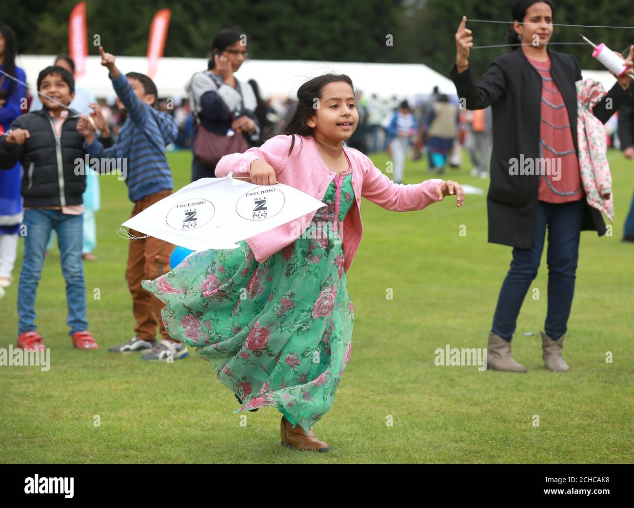 Seven year old Shnaya Singh from Hounslow joins in as hundreds of kites are launched into the sky by Zee TV to celebrate India's 70 years of Independence, in association with the Indian High Commission, in Isleworth. Stock Photo