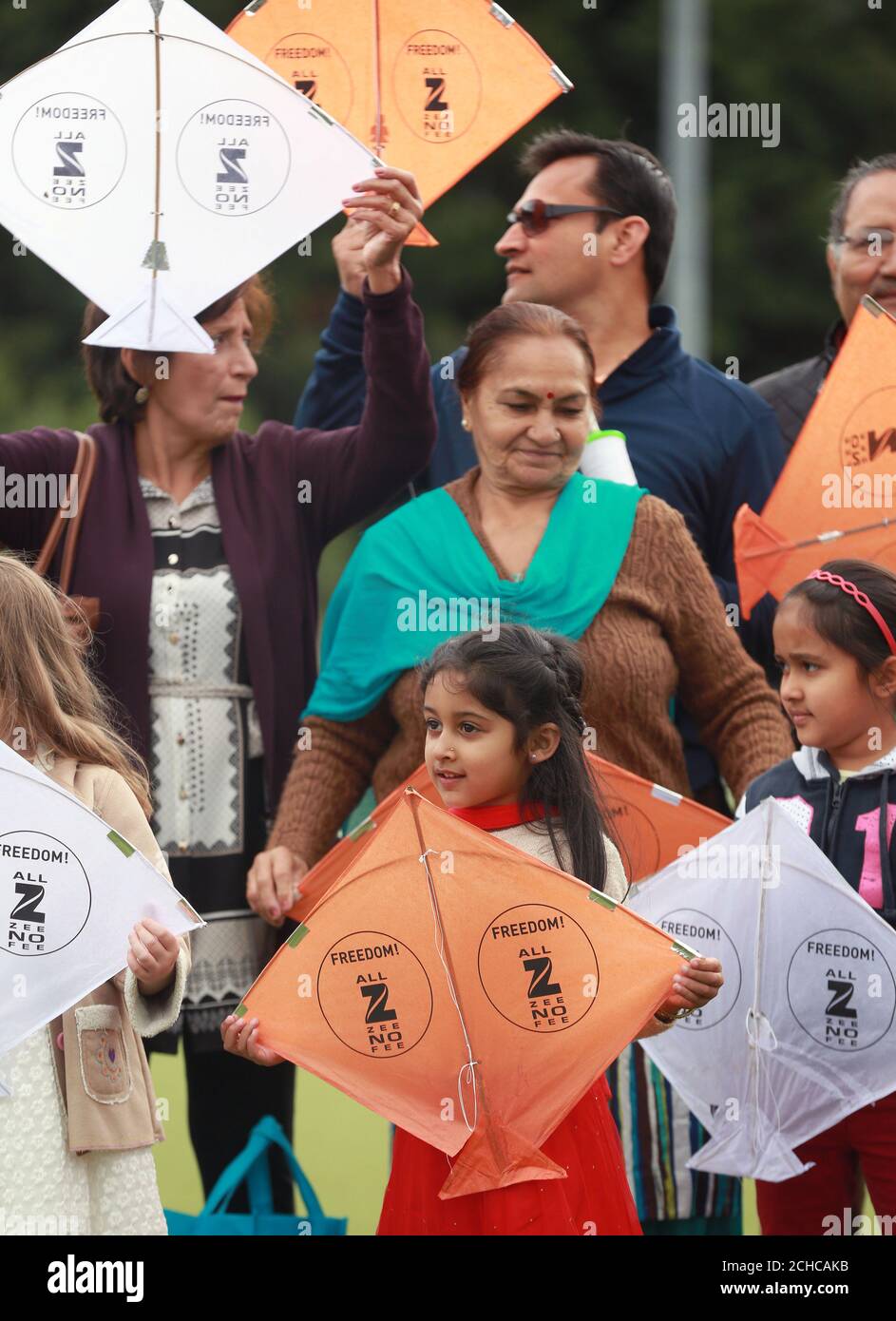 Six year old Krisha Pathak (centre) from Hounslow joins in as hundreds of kites are launched into the sky by Zee TV to celebrate India's 70 years of Independence, in association with the Indian High Commission, in Isleworth. Stock Photo