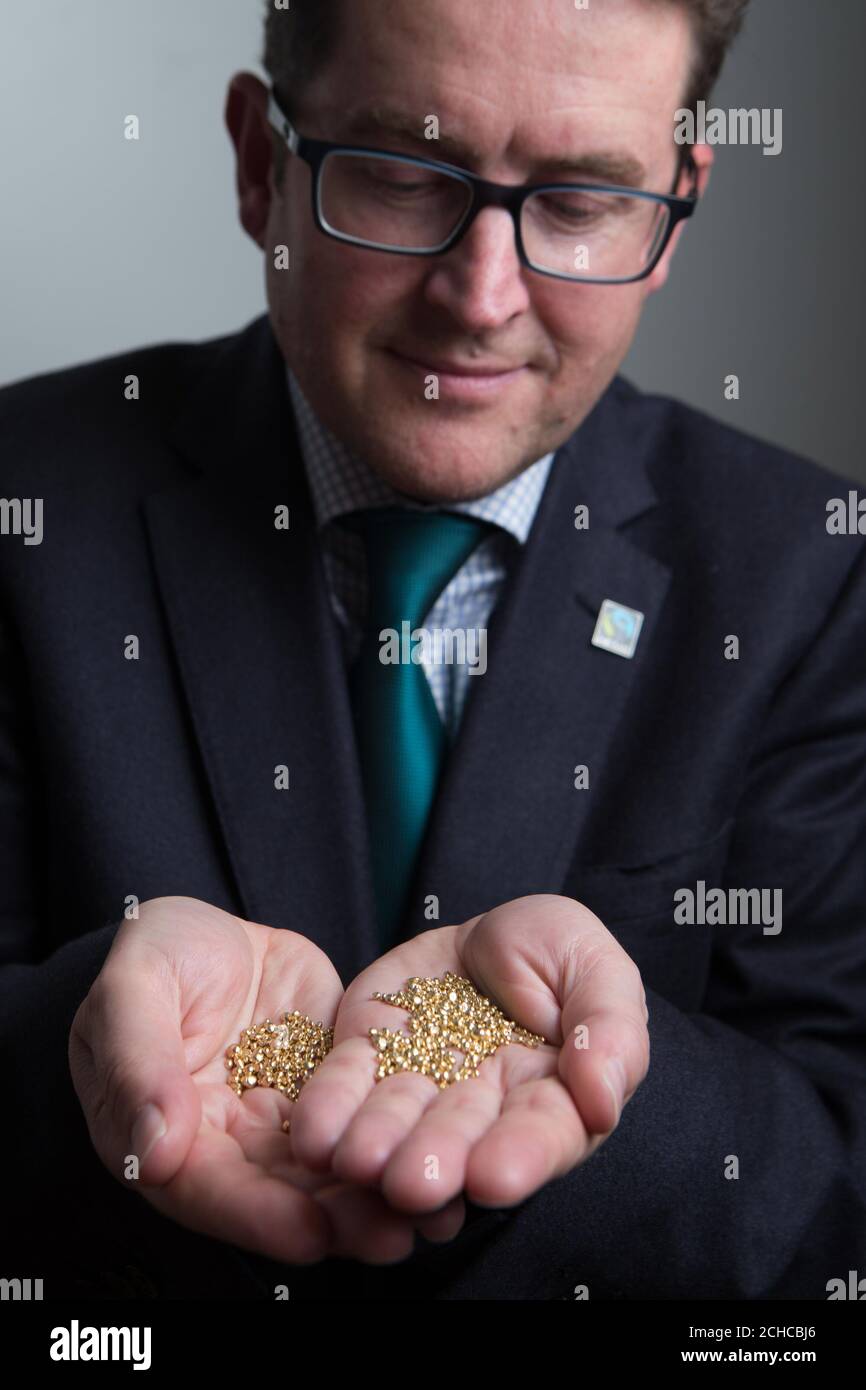 Michael Gidney, CEO of Fairtrade Foundation holds grains of African Fairtrade gold during the launch of the gold at the Goldsmith's Centre, London. PRESS ASSOCIATION. Picture date: Thursday September 21, 2017. Unregulated gold mining has led to conflicts in the mining sector, competition for land use, smuggling, child labour and human rights abuses. Fairtrade will also launch a one-off photography exhibition by award-winning Magnum photographer Ian Berry, called ÔMine to Maker', at the Goldsmiths Centre and will be open to the public until 27th October. See PA story ENVIRON Stock Photo