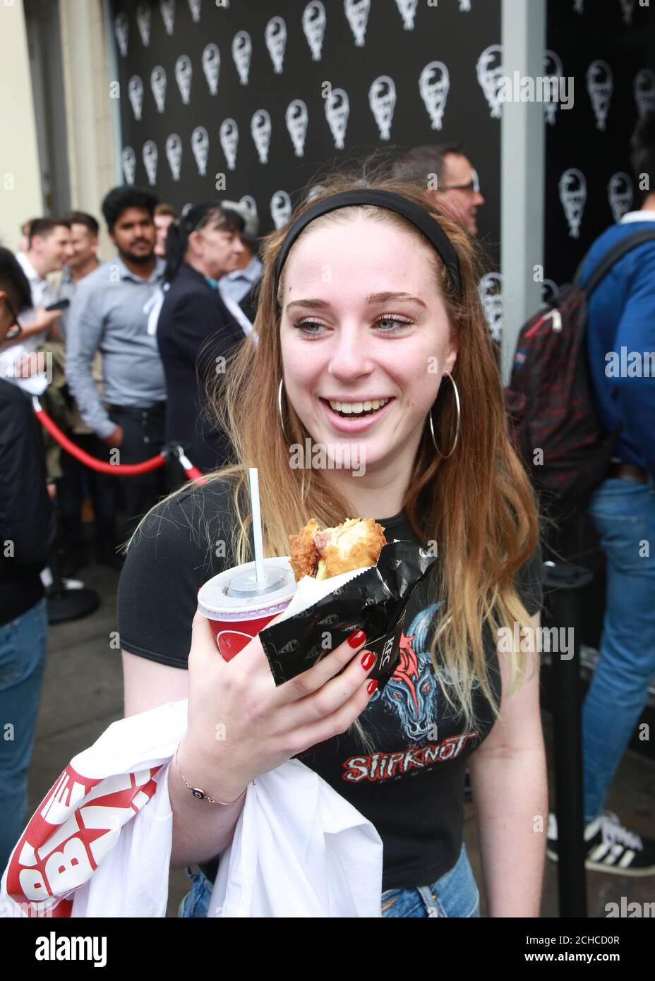 Customer Imogen Dunning from London tries the 'Double Down', which is a bun-less burger that features two Original Recipe chicken fillets, and will be on sale in the UK for 6 weeks only from October 9th, outside a branch of KFC in Gloucester Road in London Stock Photo