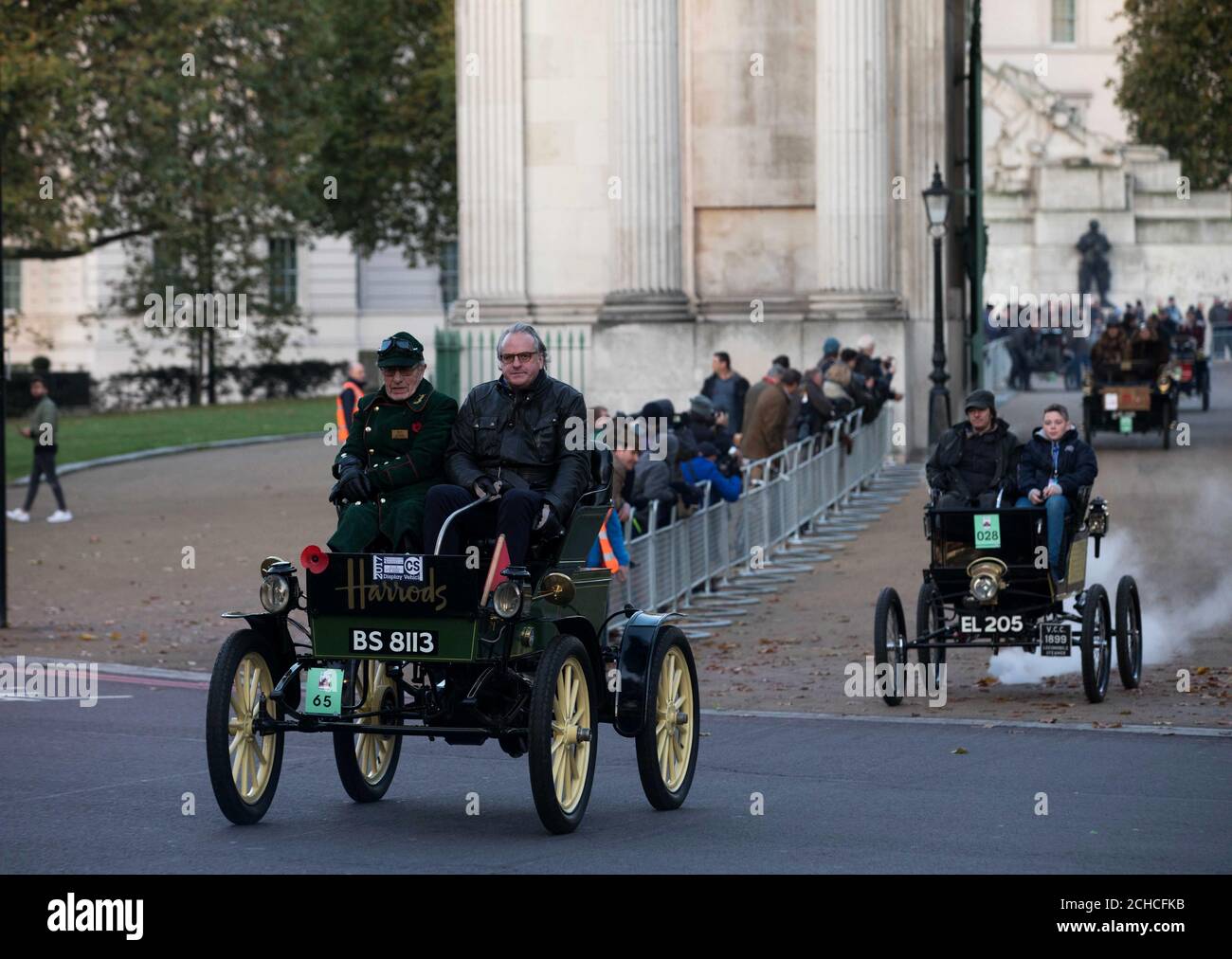 (Left-right) Len Brown Harrods curator of historic vehicles and James Healy, Harrods Director of Store Operations, driving the Harrods 1901 veteran Pope Waverley electric car through Hyde Park Corner during the annual Bonhams London to Brighton Veteran Car Run supported by Hiscox. Stock Photo
