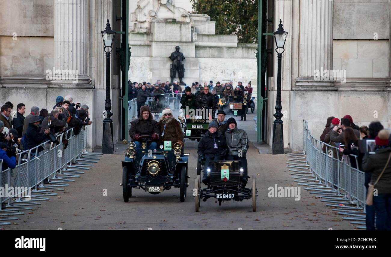 (Back left-right) Len Brown Harrods curator of historic vehicles and James Healy, Harrods Director of Store Operations, driving the Harrods 1901 veteran Pope Waverley electric car through Hyde Park Corner during the annual Bonhams London to Brighton Veteran Car Run supported by Hiscox. Stock Photo