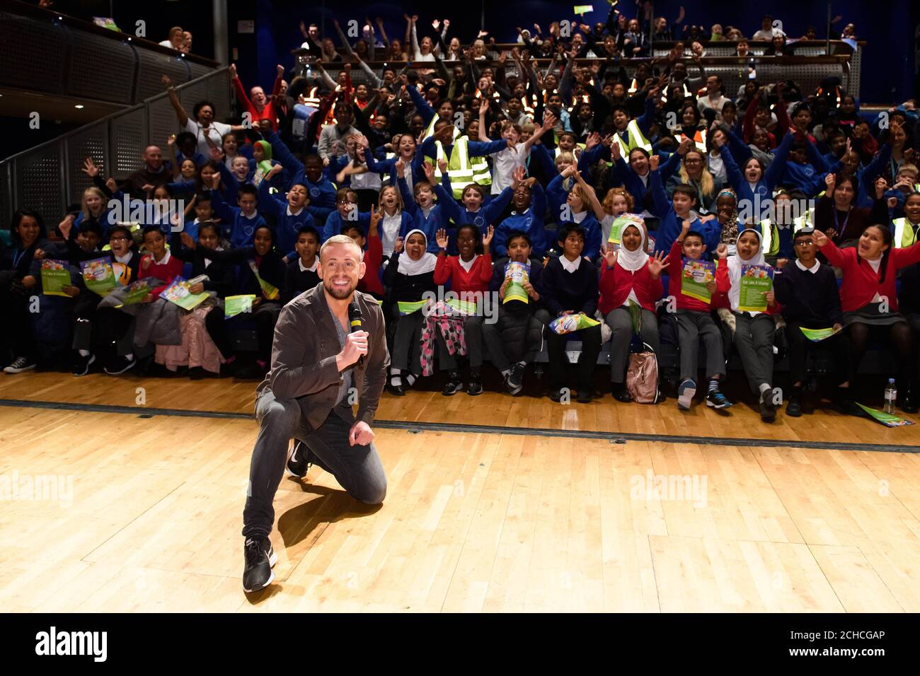 EDITORIAL USE ONLY Radio presenter Sam Pinkham with pupils and teachers from Newham at the Eat Like A Champ showcase, a free healthy eating education programme supported by Danone, which aims to promote good nutrition and lifestyle, at Stratford Circus Arts Centre in London.  Stock Photo