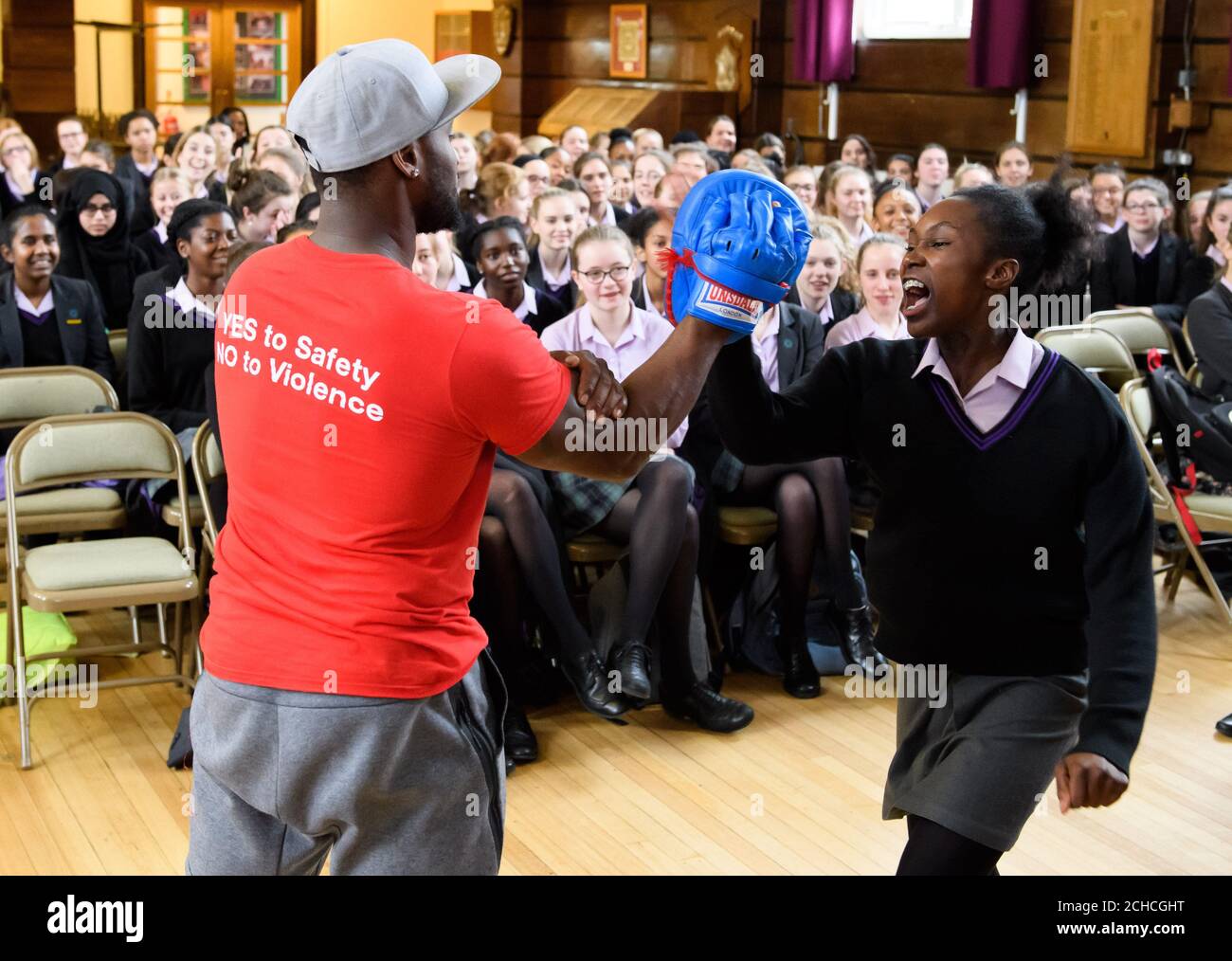 Leon Gordon, Facilitator from Action Breaks Silence, instructs Ujanah Ofuyaekpone-Shombe, aged 14, in Feminist Self-Defence at the Speak-Up Summit: an all-day immersive experience on issues from domestic violence to women's empowerment at Streatham & Clapham High School GDST, London. Stock Photo