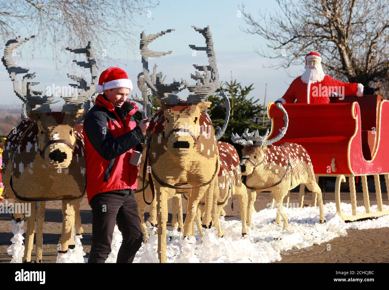 Model maker Paul Howard puts the finishing touches to one of eight reindeer, part of the 15-metre long Santa sleigh, at the Legoland Windsor Resort in Berkshire. Stock Photo