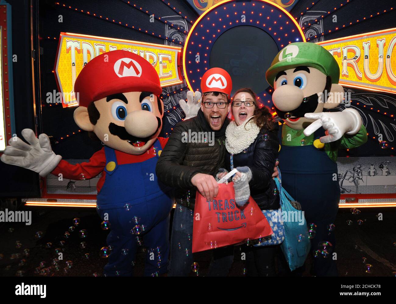 EDITORIAL USE ONLY John and Caroline Ainsbow receive their Nintendo Classic  Mini: Super Nintendo Entertainment System at the launch of Amazon Treasure  Truck in the UK at Portland Street, Manchester Stock Photo -