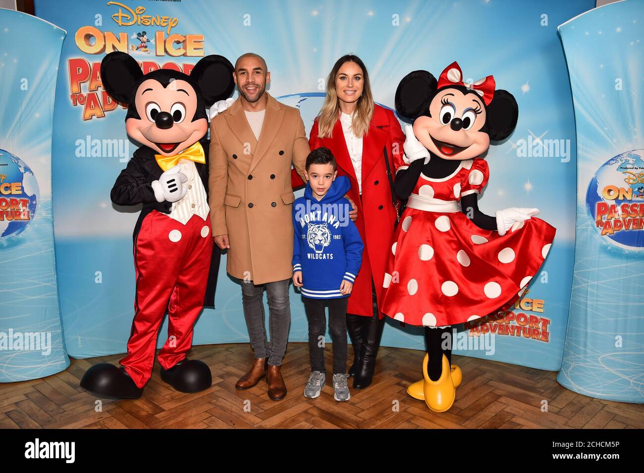 Alex Beresford, wife Natalie and son Cruz meet Mickey and Minnie Mouse at the opening night of Disney On Ice Passport to Adventure at the O2 Arena from December 20th until December 30th, London. Stock Photo