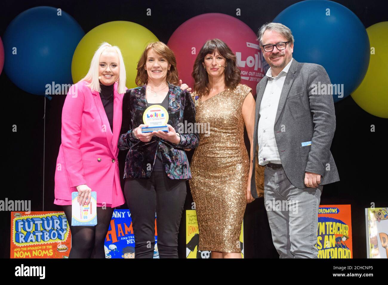 EDITORIAL USE ONLY Liz Pichon (second right) and Charlie Higson and Katie Thistleton (left) present the award for Best Laugh out Loud book for 9-12 year olds award to Christine Hamill at the Laugh Out Loud Awards, 'The Lollies', a prize giving event created by Scholastic, to celebrate the funniest children's books at the Troxy, London. PRESS ASSOCIATION. Photo. Picture date: Thursday January 18, 2018. Photo credit should read: Jonathan Hordle/PA Wire  Stock Photo