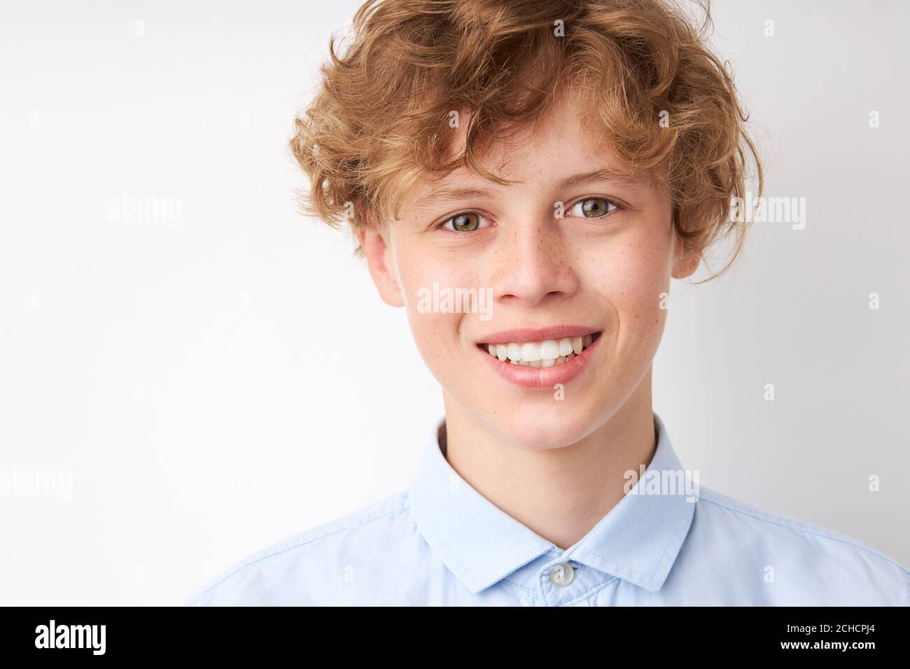 portrait of smiling young boy 14 years old isolated over white