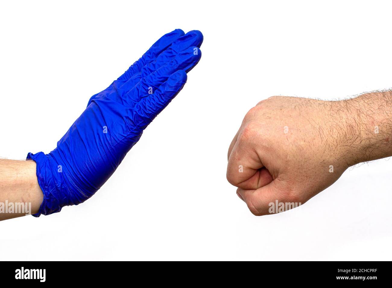 hand of a man in a blue medical glove stops an unprotected hand