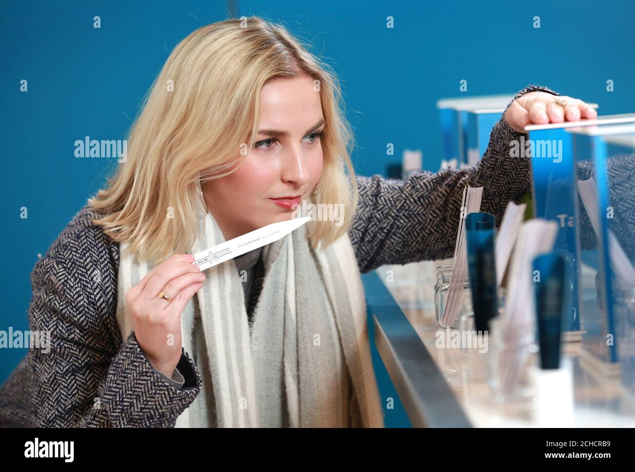 Alice Cousins, 25 from London, tries one of six bottled scents created from the natural odours of six men from online dating site Match at its pop up store called Eau.M.G (Eau Mon Garcon) in Exmouth Market, London. PRESS ASSOCIATION. Photo. Picture date: Wednesday February 7, 2018. The scents, which also feature the men's dating profiles, have been created in partnership with Parisian laboratory CARACTER, using 'olfactory photography' to capture the scent and bottle it. Smell plays a vital role in human attraction - when released by the body, a person's 'olfactory fingerpri Stock Photo