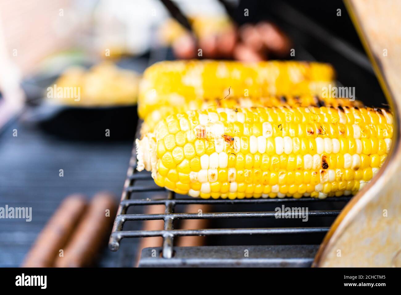 Frying small golden potatoes in cast iron skillet an outdoor gas grill