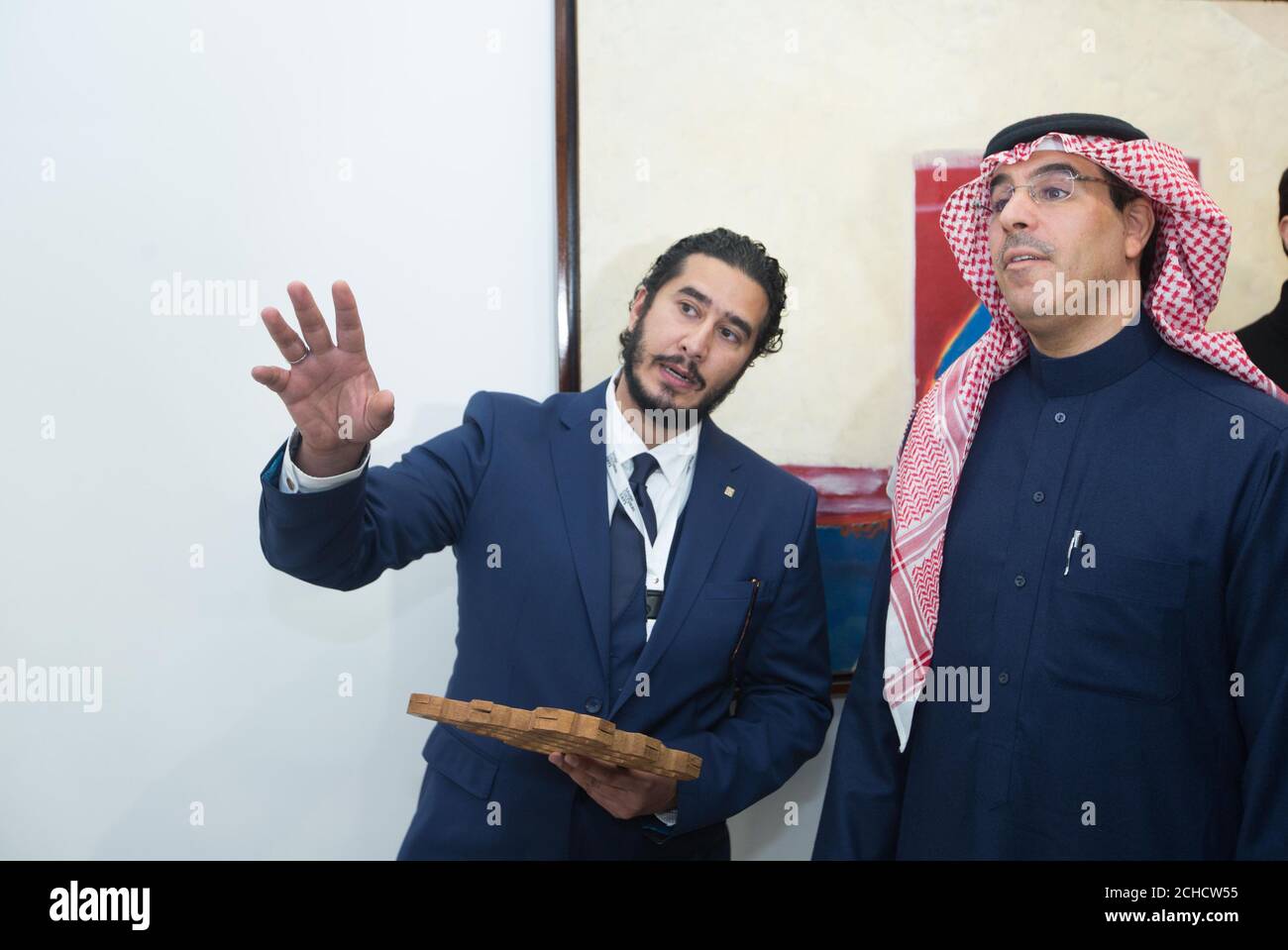 Artist Ahmad Angawi (left) shows Awwad Bin Saleh Al-Awwad, Saudi Arabia's Minister of Culture and Information and Chairman of the Board of the General Culture Authority his work at Saudi Cultural Days, a three-day programme highlighting Saudi art and culture which takes place until Friday 9th March 2018 at Phillips in Mayfair, London. PRESS ASSOCIATION. Photo. Picture date: Wednesday March 7, 2018. The event has been organised by Saudi Arabia's General Culture Authority (GCA), in cooperation with the Prince Mohammed bin Salman bin Abdulaziz Foundation (MiSK) and Phillips. P Stock Photo