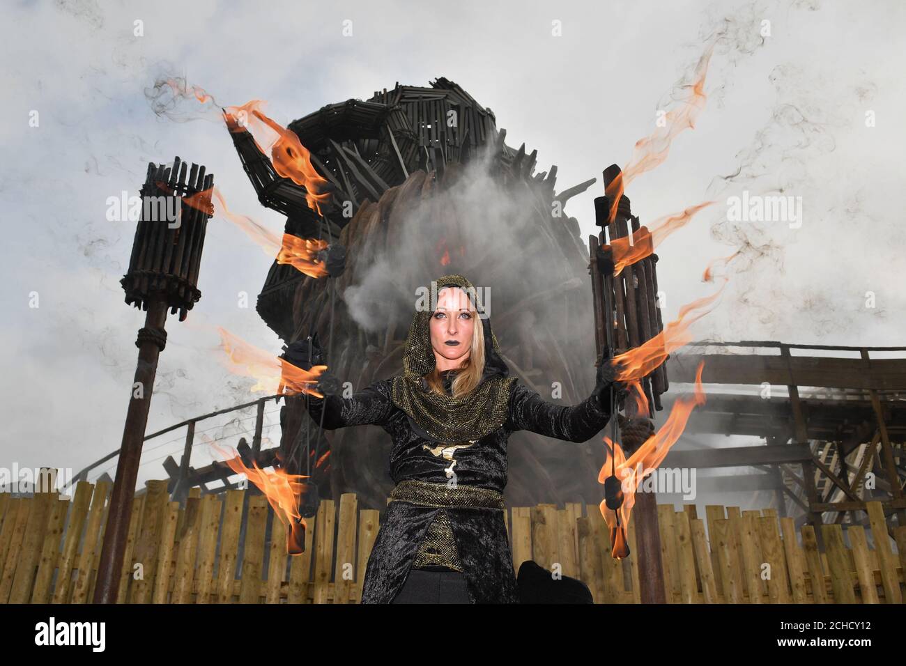 An actress dressed as a Beornen performs with fire at Alton Towers Resort in Stoke-on-Trent, for the opening of the Wicker Man, a wooden rollercoaster which features a six-storey flaming structure. Stock Photo