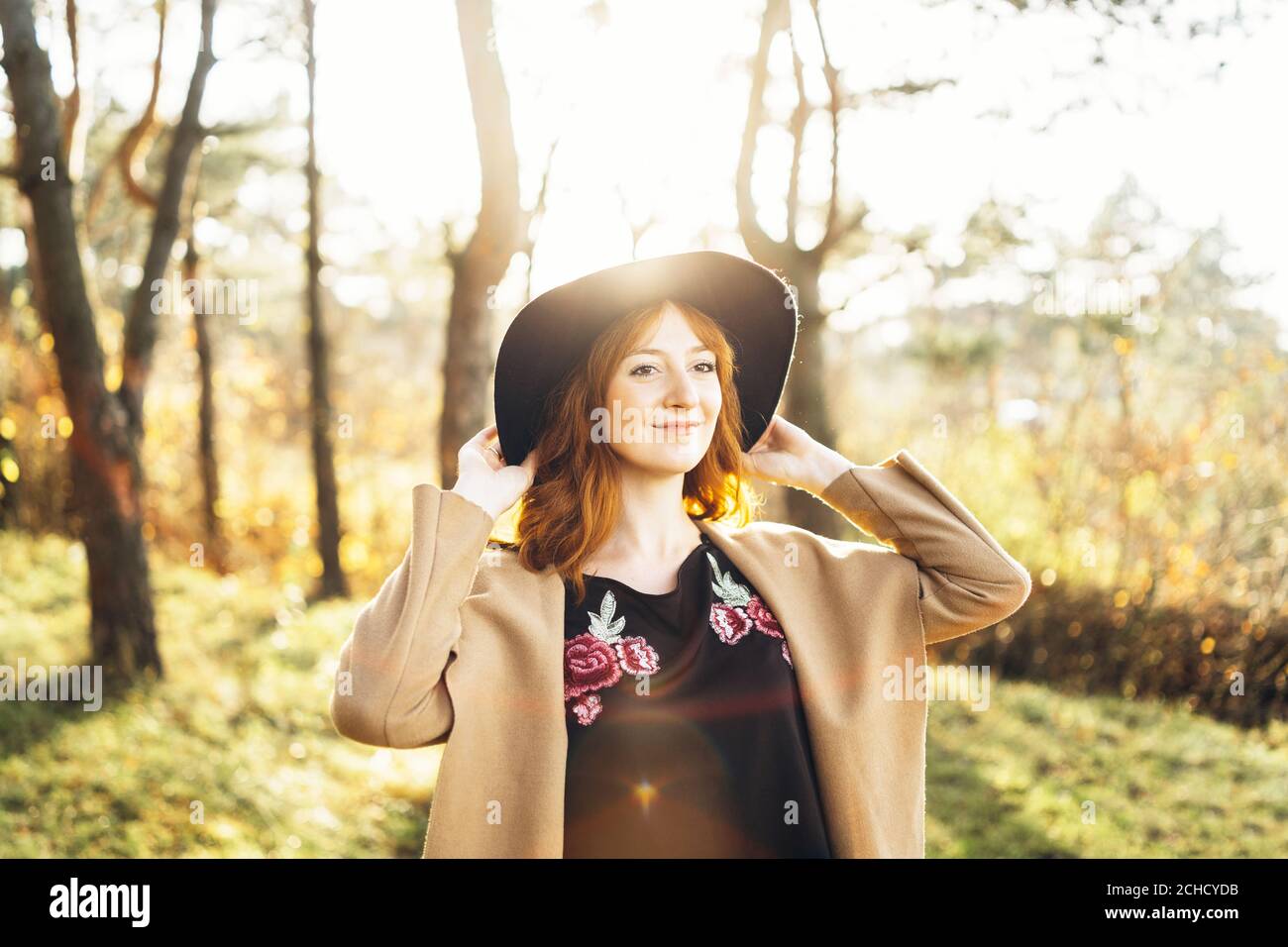 Pretty and happy red hair girl walking in the forest Stock Photo - Alamy