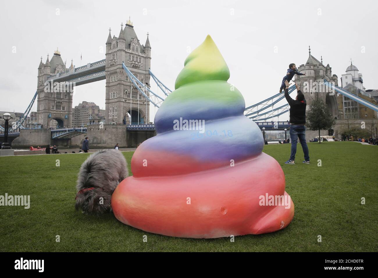 Mixed-breed rescue Ruby, interacts with a 'rainbow poo' model at Potters Fields Park in London, to announce a new service from mobile provider THREE, which launches on Thursday April 26th. Stock Photo