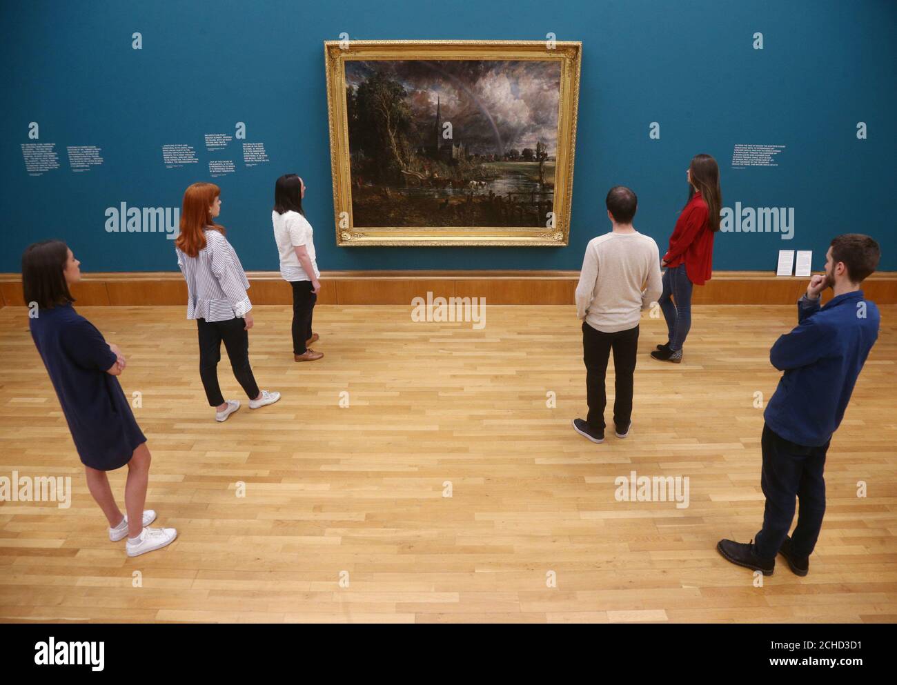 Gallery staff looking at John Constable's Salisbury Cathedral from the Meadows, 1831, during a photo call for Tate Britain's new exhibition, Fire and Water, a display of Constable and Turner, in London. Stock Photo