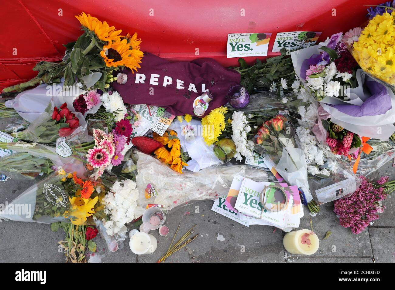 Floral tributes underneath a mural of Savita Halappanavar called aches in Dublin as votes are counted in the referendum on the 8th Amendment of the Irish Constitution which prohibits abortions unless a mother's life is in danger. Stock Photo