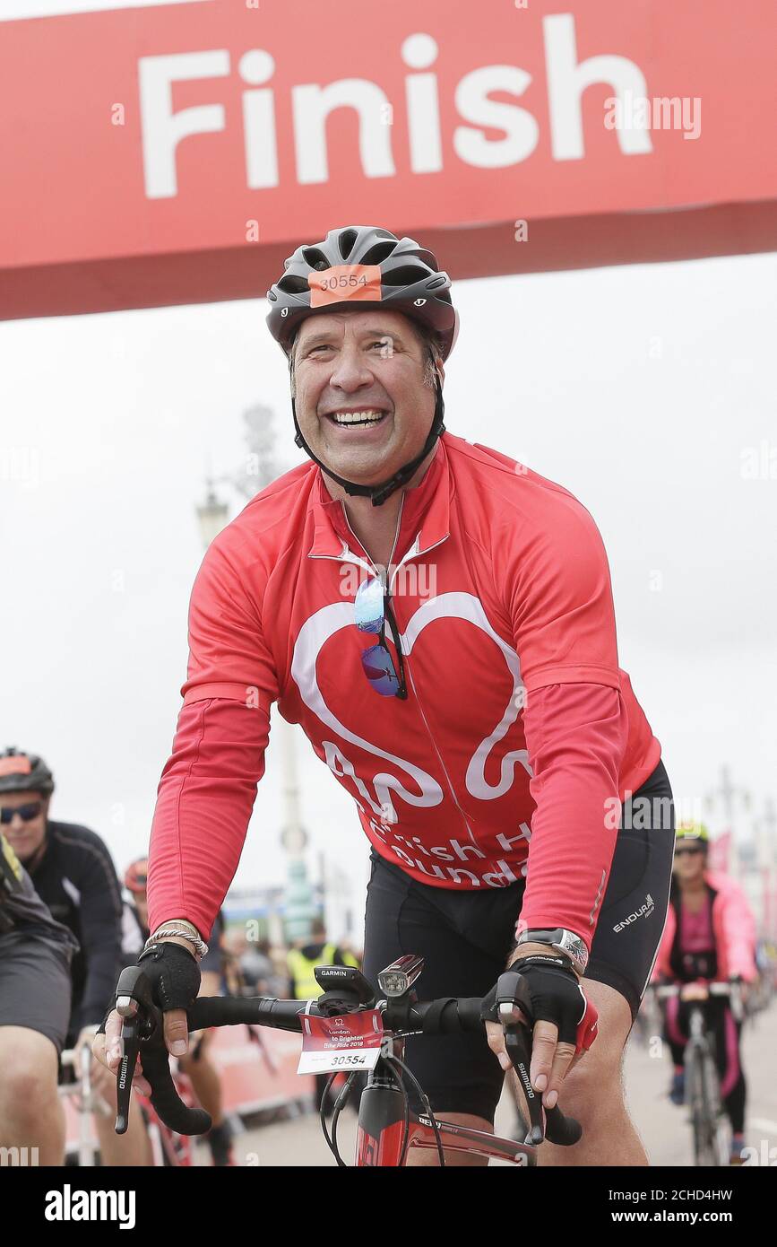 EDITORIAL USE ONLY David Seaman celebrates after finishing the British Heart Foundation's London to Brighton Bike Ride 2018. PRESS ASSOCIATION. Photo. Picture date: Sunday June 17, 2018. David joined 16,000 cyclists this year, helping raise around £3million for the charity's life-saving research. Heart and circulatory disease is responsible for around 150,000 deaths each year. Photo credit should read: Tim Ireland/PA Wire Stock Photo