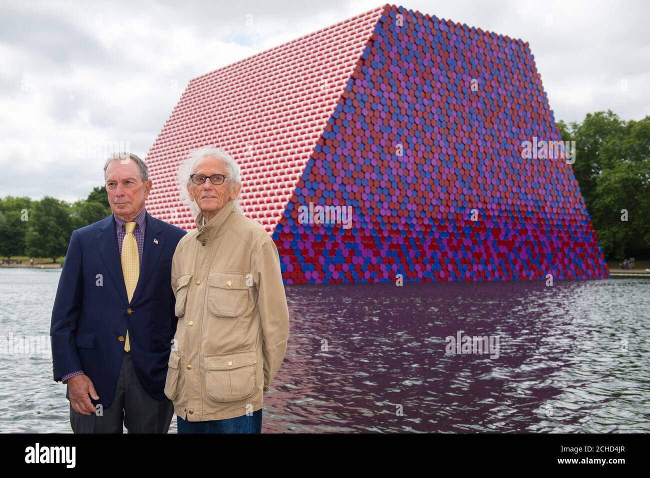 Artist Christo (right) and Michael Bloomberg with the London Mastaba, the first major work in London by the internationally acclaimed artist, Christo. PRESS ASSOCIATION Photo. Picture date: Monday June 18, 2018. The sculpture (20m high by 30m wide and 40m long) consists of 7,506 horizontally stacked barrels on a floating platform in the Serpentine Lake. It will be on view until 23 September 2018 to coincide with an exhibition at the Serpentine Galleries of Christo and his late wife Jeanne Claude's work. Photo credit should read: Dominic Lipinski/PA WirePRESS ASSOCIATION Photo. Picture date: Mo Stock Photo