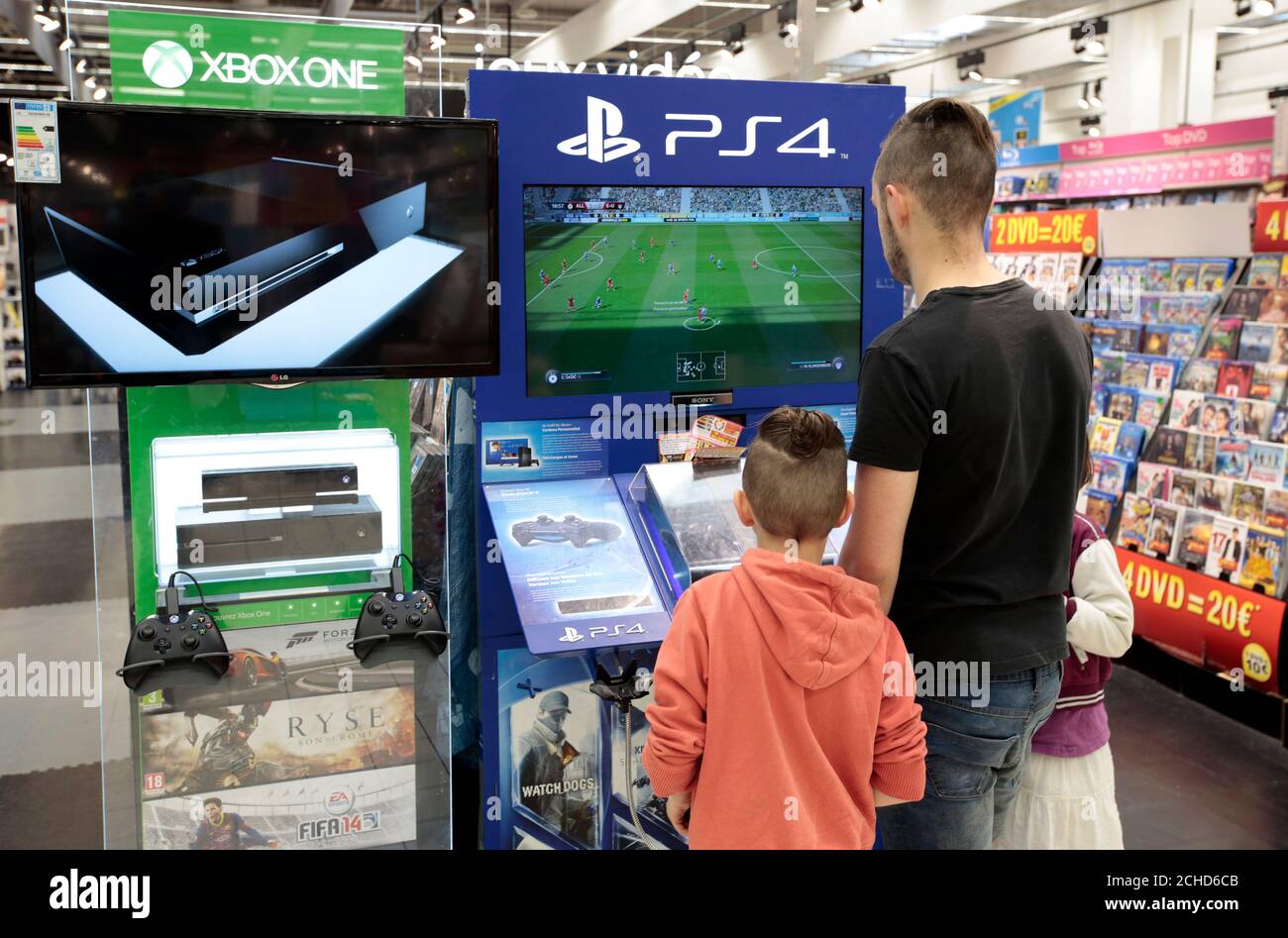 Customers look at games on PlayStation 4 (PS4) at a Carrefour hypermarket  in Nice, France, April 6, 2016. REUTERS/Eric Gaillard Stock Photo - Alamy