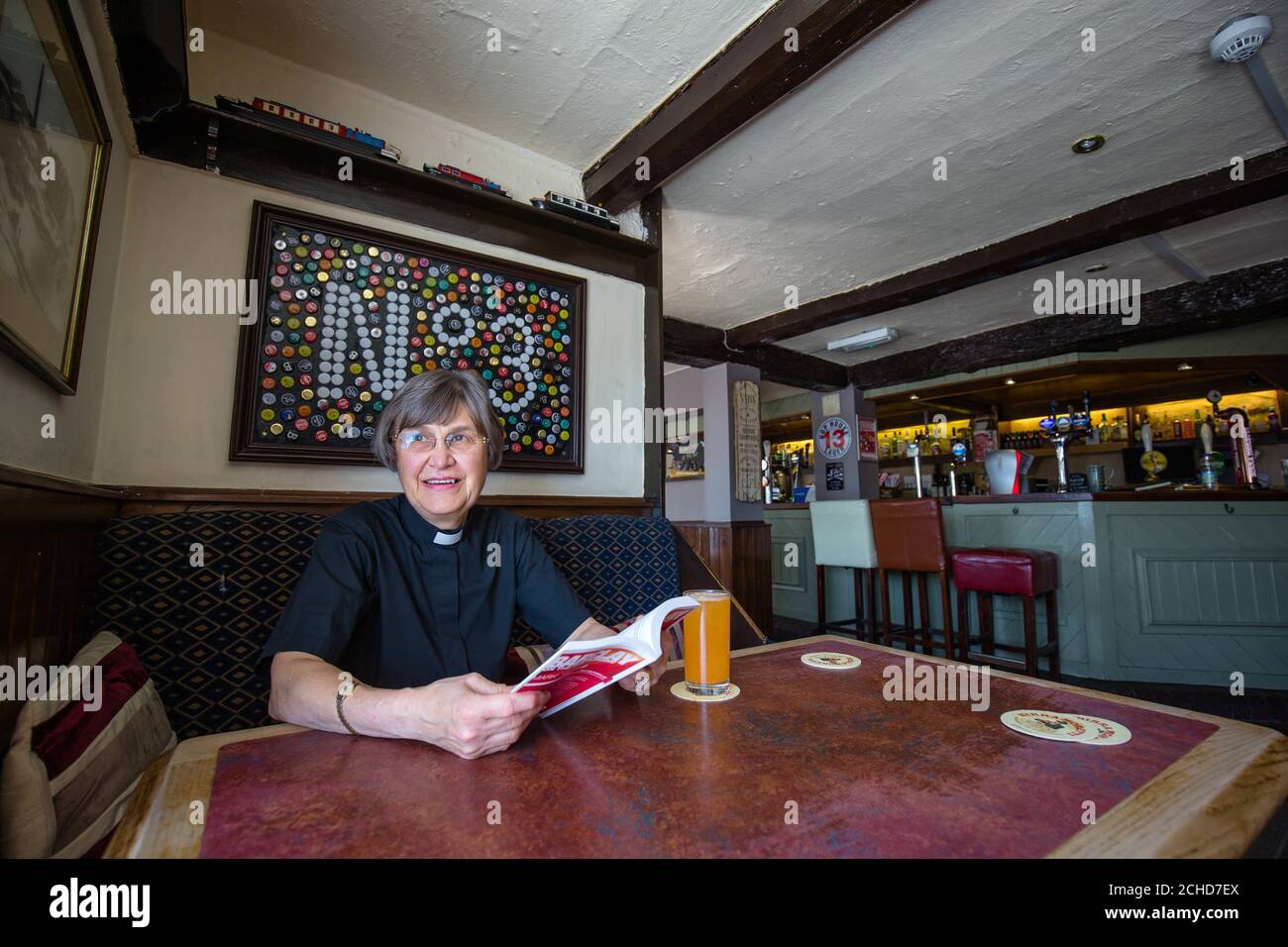 Vicar Patricia Robinson supports her local pub Ye Olde No.3 in Altrincham to celebrate the start of National Pub Fortnight, which starts on July 20th, Greater Manchester. Stock Photo