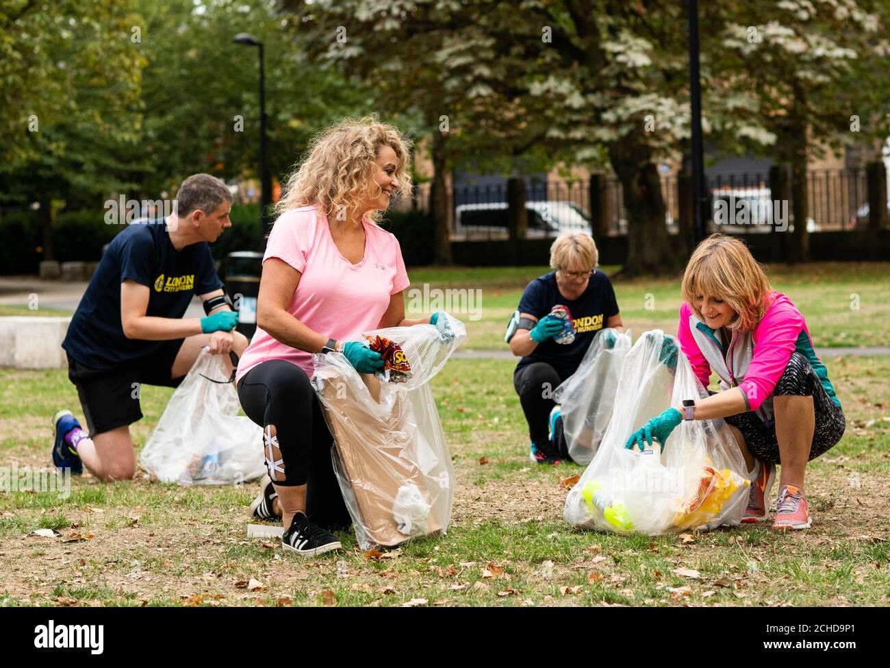 Nadia Sawalha and Kaye Adams (right) go 'Plogging', which is a Scandinavian fitness trend where people pick up plastic whilst out walking or running, with Fitbit and London City Runners in support of WasteAid, in central London. Stock Photo