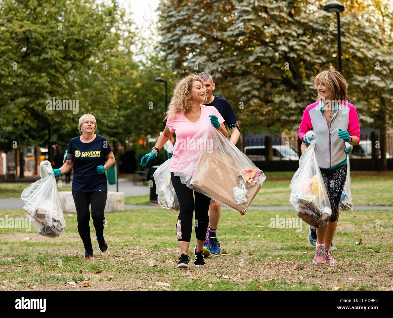 EDITORIAL USE ONLY Nadia Sawalha and Kaye Adams (right) go 'Plogging', which is a Scandinavian fitness trend where people pick up plastic whilst out walking or running, with Fitbit and London City Runners in support of WasteAid, in central London. Stock Photo