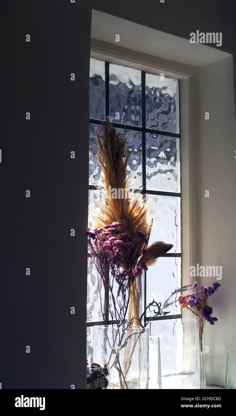 dried flowers and grasses on London kitchen window sill Stock Photo