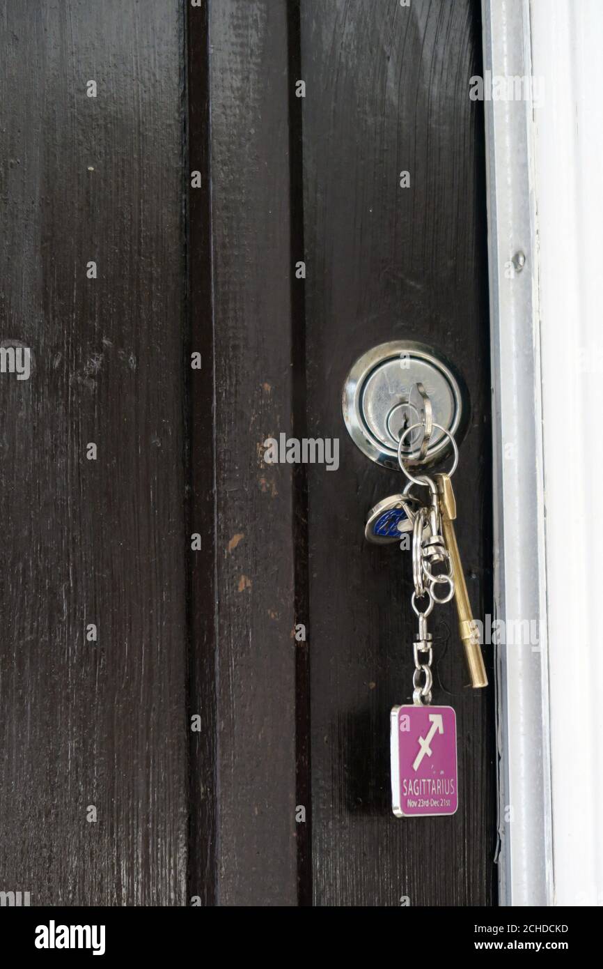 front door with keys in lock Stock Photo
