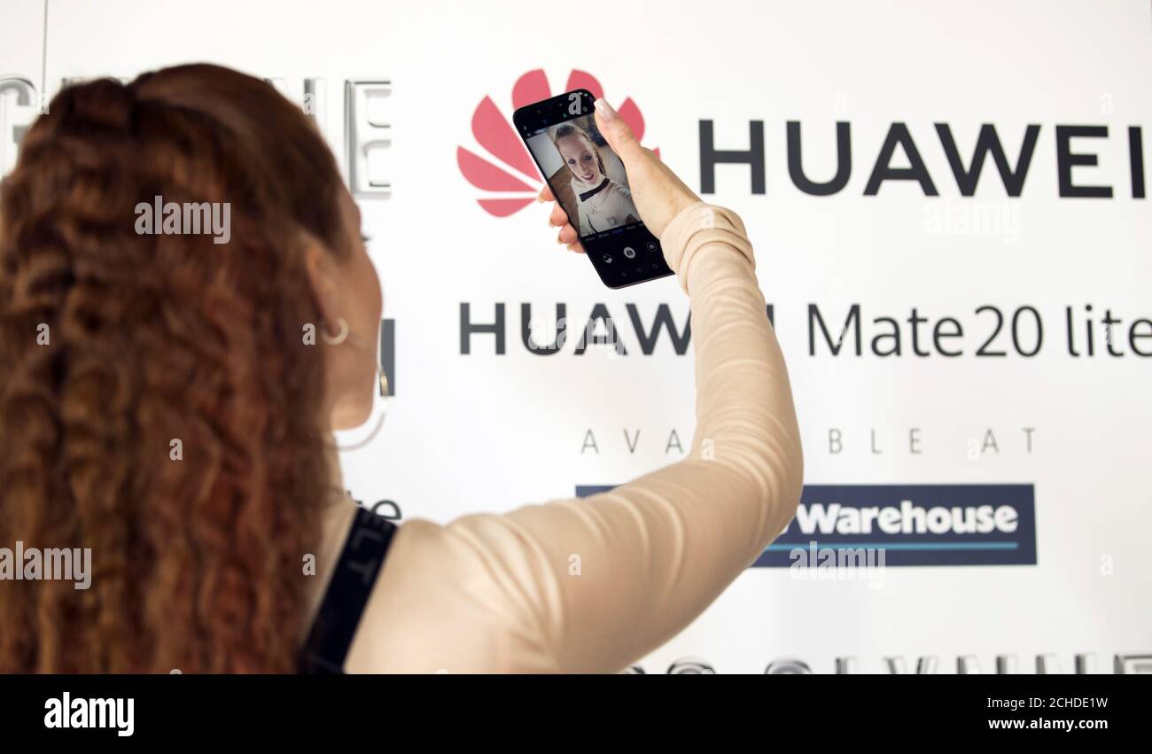 EDITORIAL USE ONLY Jess Glynne tries out the new Huawei Mate 20 lite handset ahead of performing for fans at the Albert Hall in Manchester, hosted by Huawei & Carphone Warehouse to celebrate the release of the new Mate 20 lite handset. Stock Photo