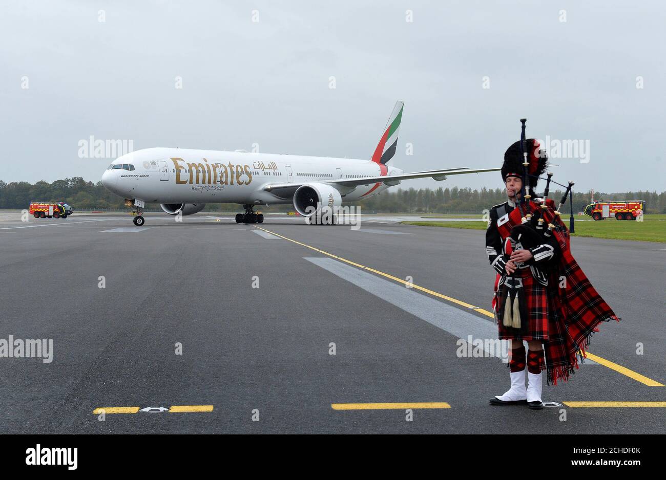 EDITORIAL USE ONLY An Emirates Boeing 777 300ER Is Met By A Piper At editorial-use-only-an-emirates-boeing-777-300er-is-met-by-a-piper-at