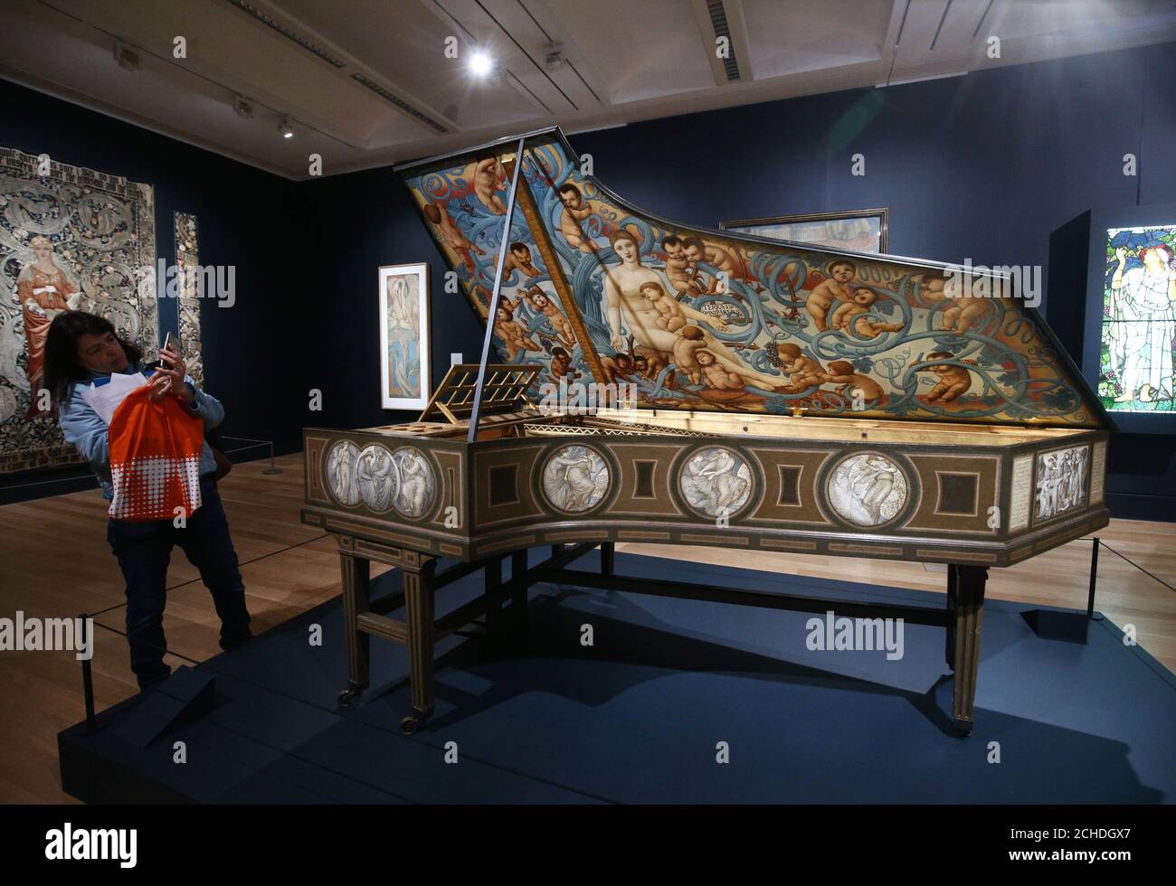 A woman photographs The Graham Piano, 187980, by Edward BurneJones