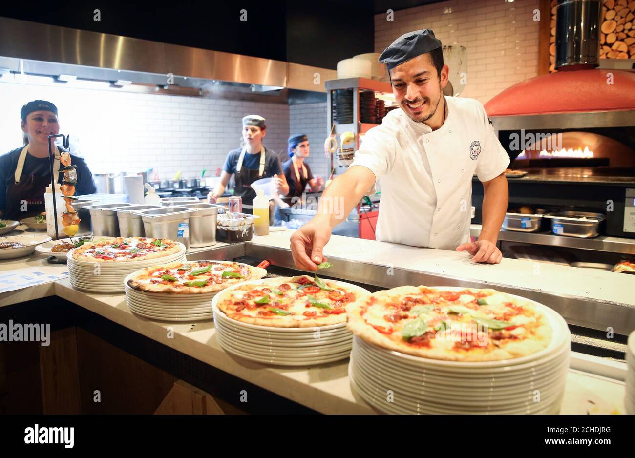 EDITORIAL USE ONLY Chef Messaadia Imad at work making pizzas as Zizzi's Salisbury restaurant is officially reopened, eight months after it was caught up in the poisoning of a former Russian intelligence officer and his daughter. Stock Photo