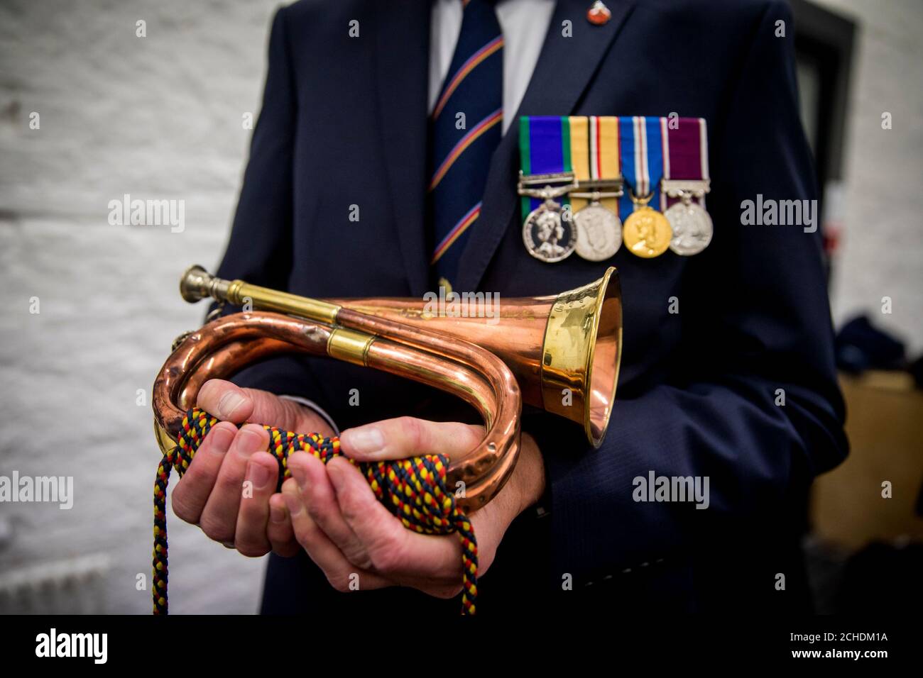 Bugler Noel Trimble holds the bugle that sounded the charge of the 36th