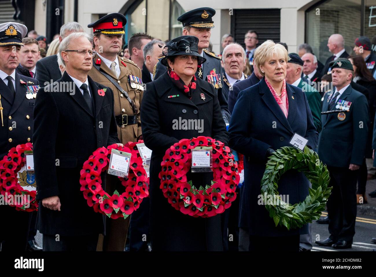 Sir Jonathan Stephens Permanent Secretary at the Northern Ireland Office (left) on behalf of the Karen Bradley Secretary of State for Northern Ireland, DUP leader Arlene Foster (centre) and Heather Humphreys (right) Irish Minister for Business, Enterprise and Innovation at the Enniskillen Cenotaph during Remembrance Sunday in Enniskillen in County Fermanagh, Northern Ireland, on the 100th anniversary of the signing of the Armistice which marked the end of the First World War. Stock Photo