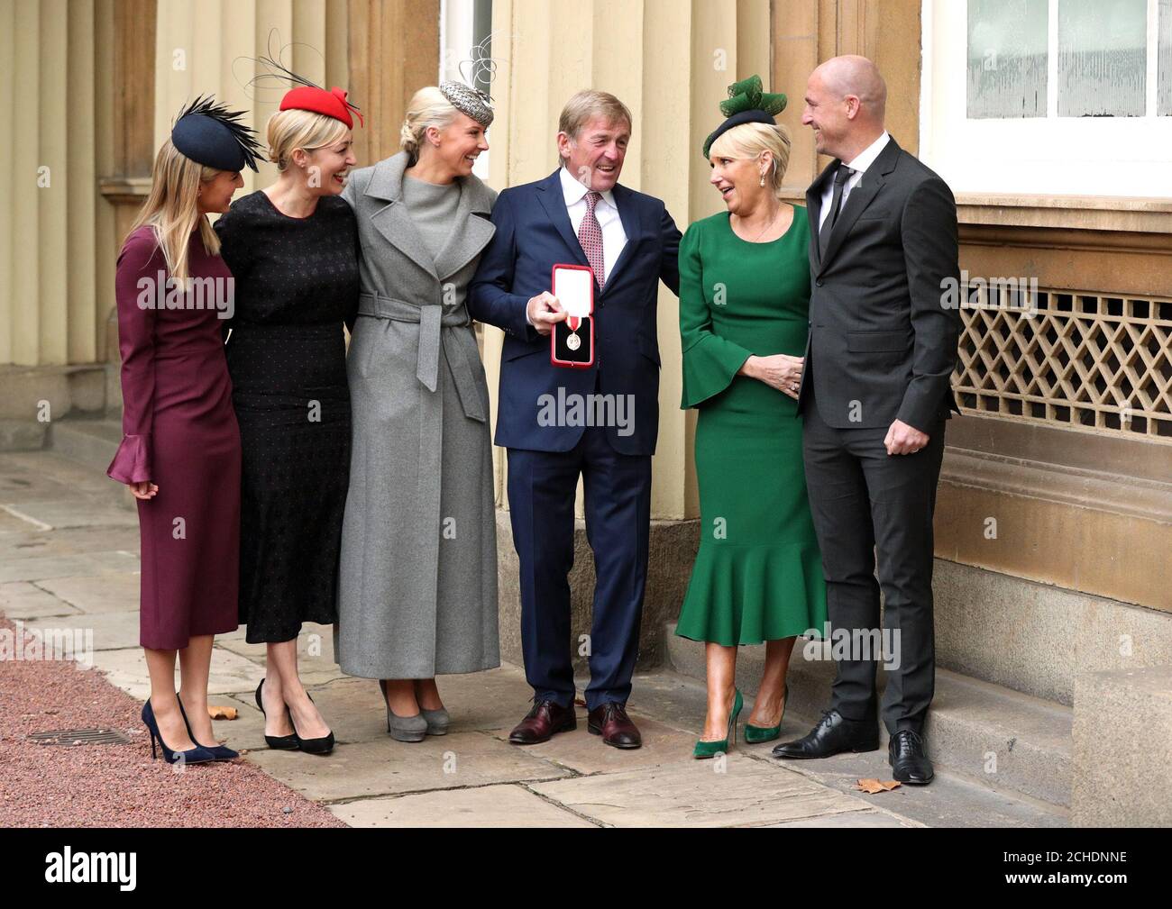 Liverpool legend Sir Kenny Dalglish with his family after being knighted at an investiture ceremony at Buckingham Palace, London. Stock Photo