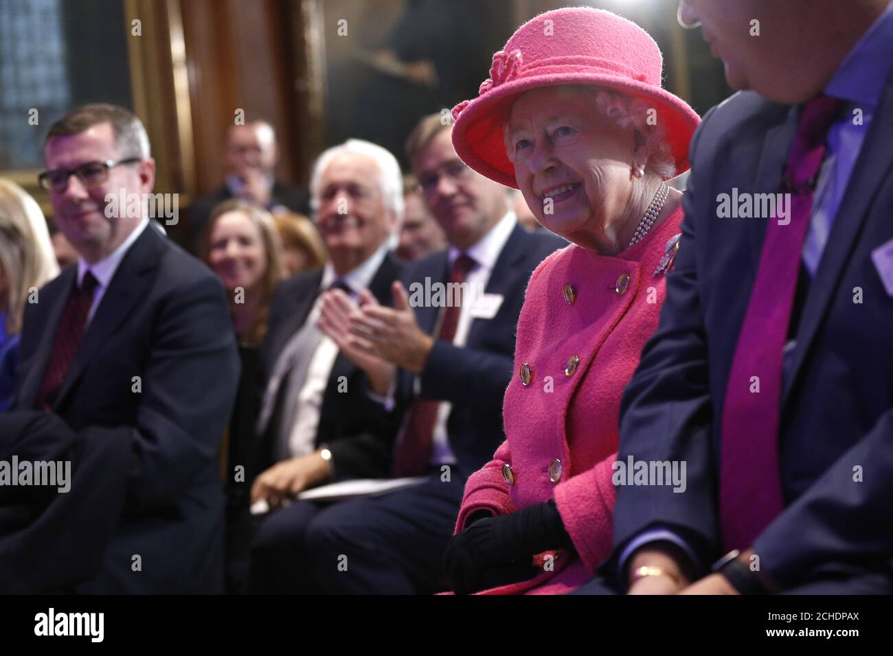 Queen Elizabeth II smiles during a visit to the Royal Institution of Chartered Surveyors (RICS) in London, to mark its 150th anniversary. Stock Photo