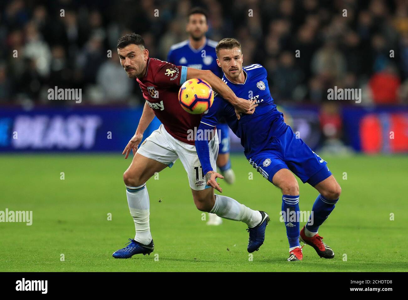 West Ham United's Robert Snodgrass (left) and Cardiff City's Joe Bennett battle for the ball during the Premier League match at the London Stadium. Stock Photo
