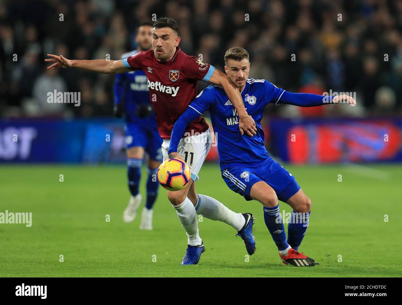 West Ham United's Robert Snodgrass (left) and Cardiff City's Joe Bennett battle for the ball during the Premier League match at the London Stadium. Stock Photo