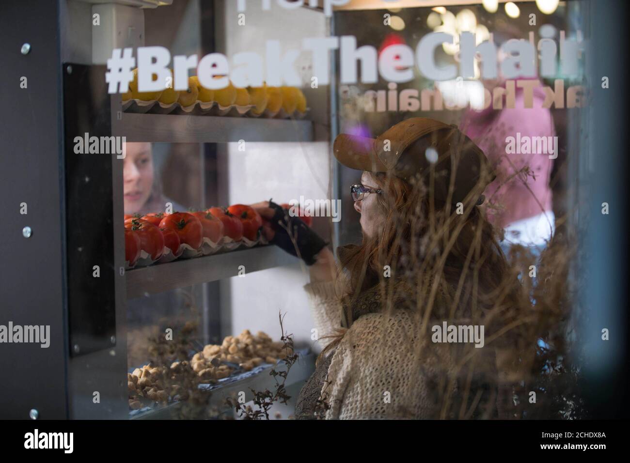 EDITORIAL USE ONLY Courtney Derrico a student from the University of Hull trapped inside a human vending machine to illustrate modern-day slavery practices hidden within our food, on Human Rights Day in London. Stock Photo