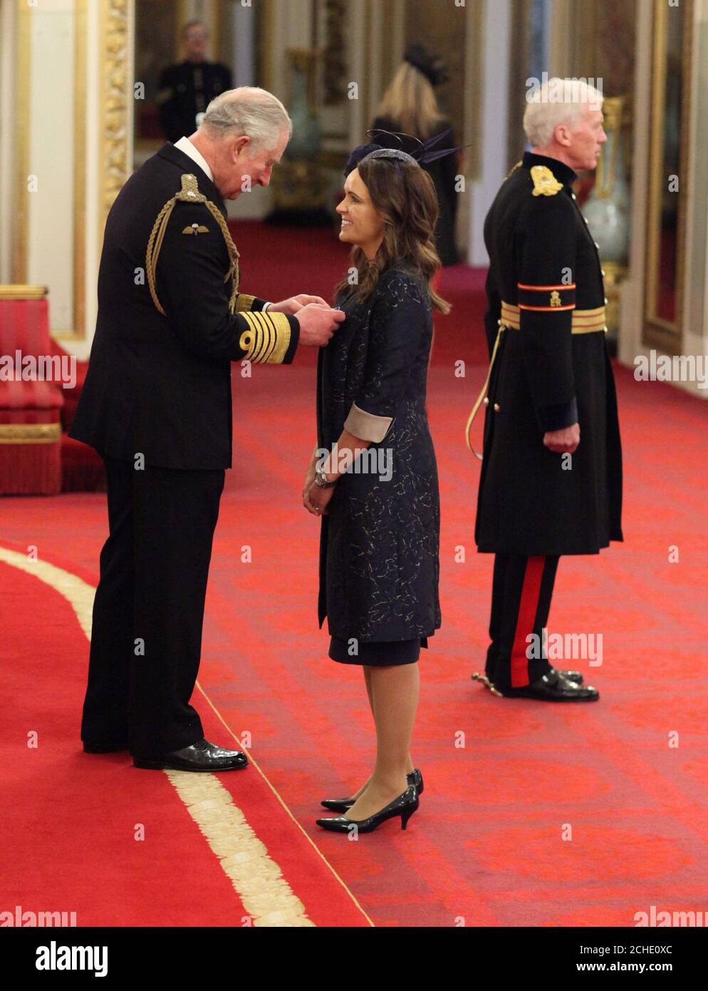 Sara Booth is made an MBE (Member of the Order of the British Empire) by the Prince of Wales at Buckingham Palace. Stock Photo